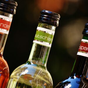 Three wine bottles with labels from France, Germany, and Spain, showcasing diverse wine cultures.